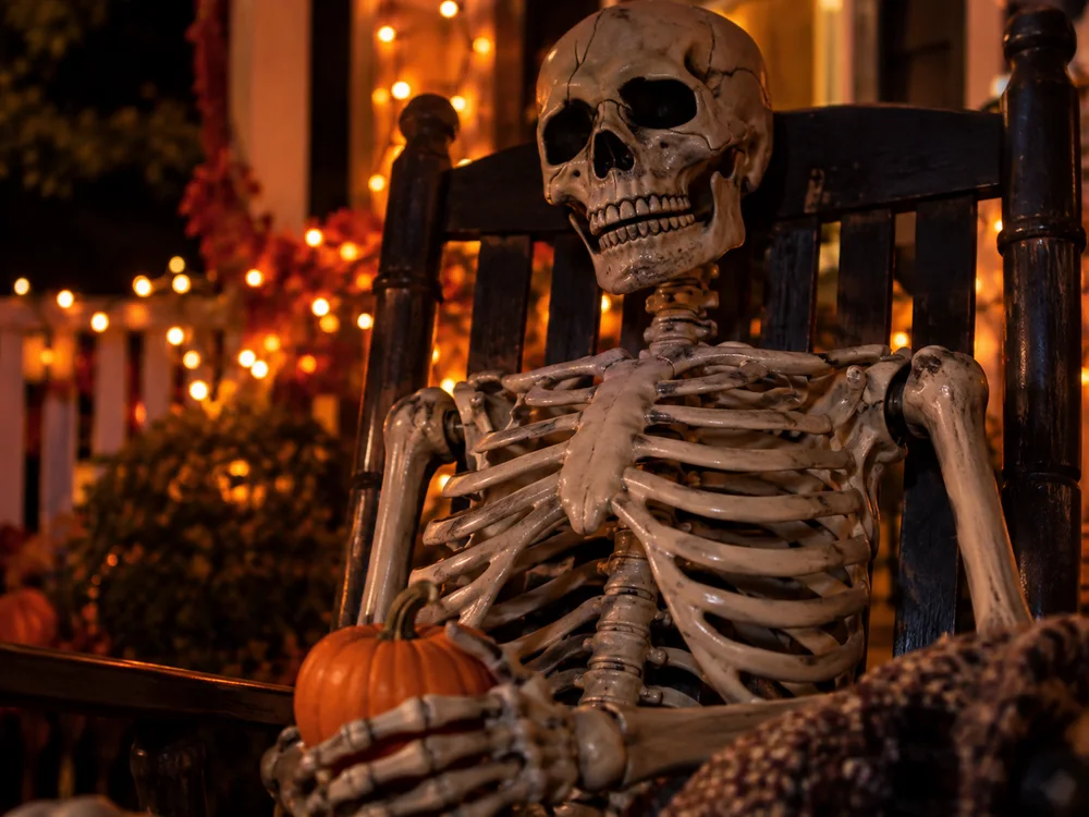 Illustrative close-up of a skeleton decoration in a rocking chair